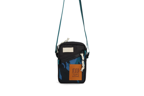 Small black crossbody bag with blue accents and a visible brand logo on a white background