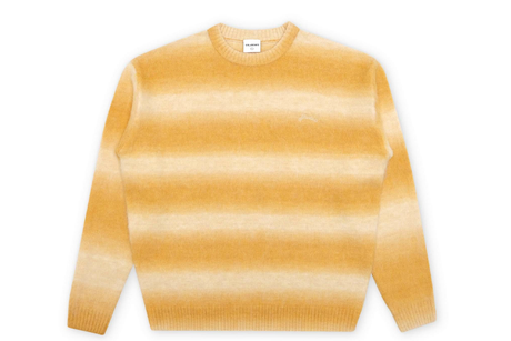 Yellow and beige striped sweater on a white background