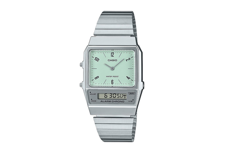 A Casio watch with a silver stainless steel band and a green analog dial, displaying time and date.