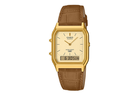 Casio watch with gold case and brown leather strap on a white background