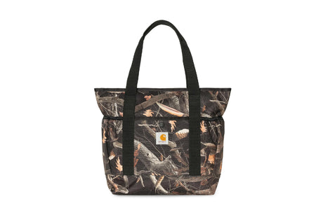 A Carhartt tote bag featuring a brown and black woodland camouflage pattern, with black shoulder straps and a small white Carhartt logo patch on the front pocket, set against a plain white background.