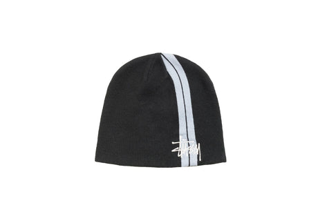A black knit beanie hat featuring a vertical white stripe down the center and a white embroidered Stüssy logo near the bottom, set against a plain white background.