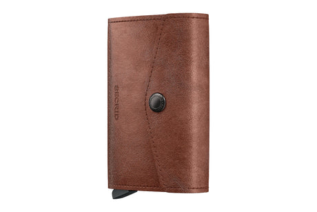 A brown leather wallet with a snap-button closure and a small black tab at the bottom, shown on a plain white background.
