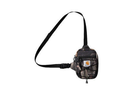 A small crossbody fanny pack in a dark camouflage pattern with a black strap, featuring a visible Carhartt logo patch on the front pocket.