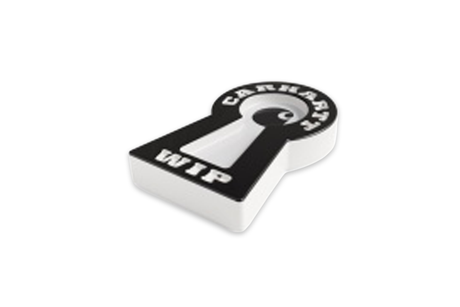 White key-shaped ashtray with black details on a white background