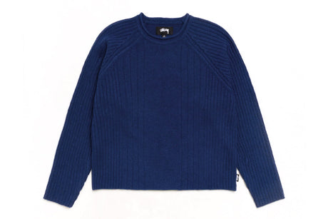 A navy blue ribbed knit sweater with raglan sleeves, laid flat against a white background.