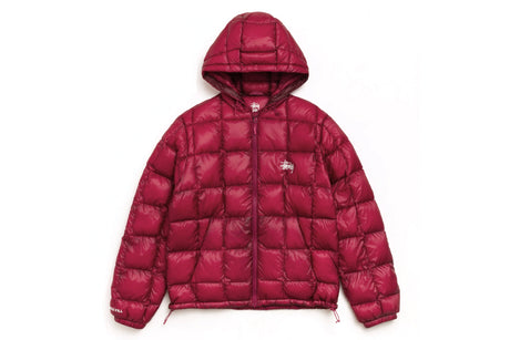 A dark red puffer jacket with a hood, featuring horizontal quilting and a small white embroidered logo on the left chest, displayed against a plain white background.