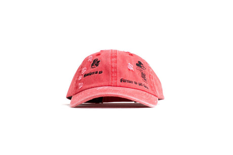 Pink cap with embroidered designs on a white background