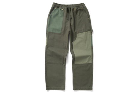 A pair of olive green patchwork cargo pants with a drawstring waist, displayed flat against a plain white background.