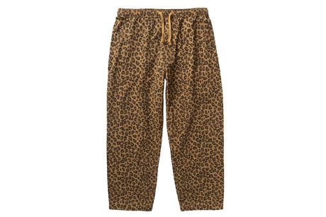 Leopard print lounge pants with an elastic waistband and tan drawstring, shown flat against a white background.