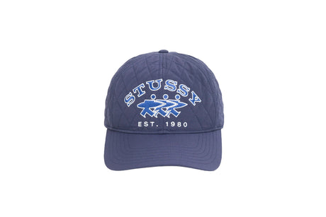 A navy blue Stussy baseball cap with white embroidered text reading 'STUSSY' and 'EST. 1980' along with the brand's logo, shown against a plain white background.