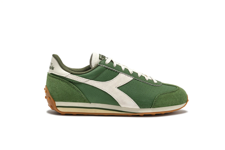 Green and white sneaker with brown sole on a white background