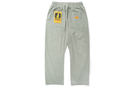 Gray sweatpants with a logo on the chest pocket against a white background
