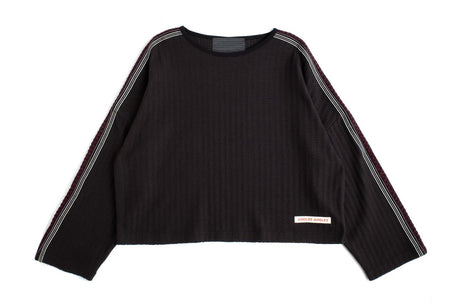 Cropped  black sweater with Triple Tape Knit down the sleeve on a white background. 
