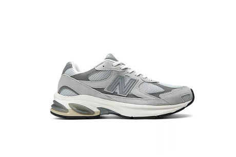 Gray athletic shoe with New Balance logo on a white background