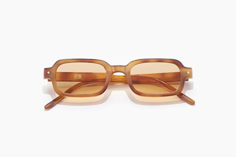 Rectangular acetate sunglasses with a warm brown tortoiseshell frame and translucent amber lenses, shown on a clean white background.